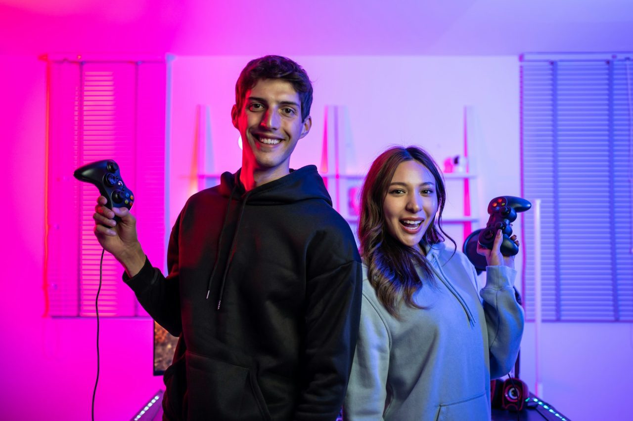 portrait-of-e-sport-couple-gamer-playing-online-video-game-on-computer-